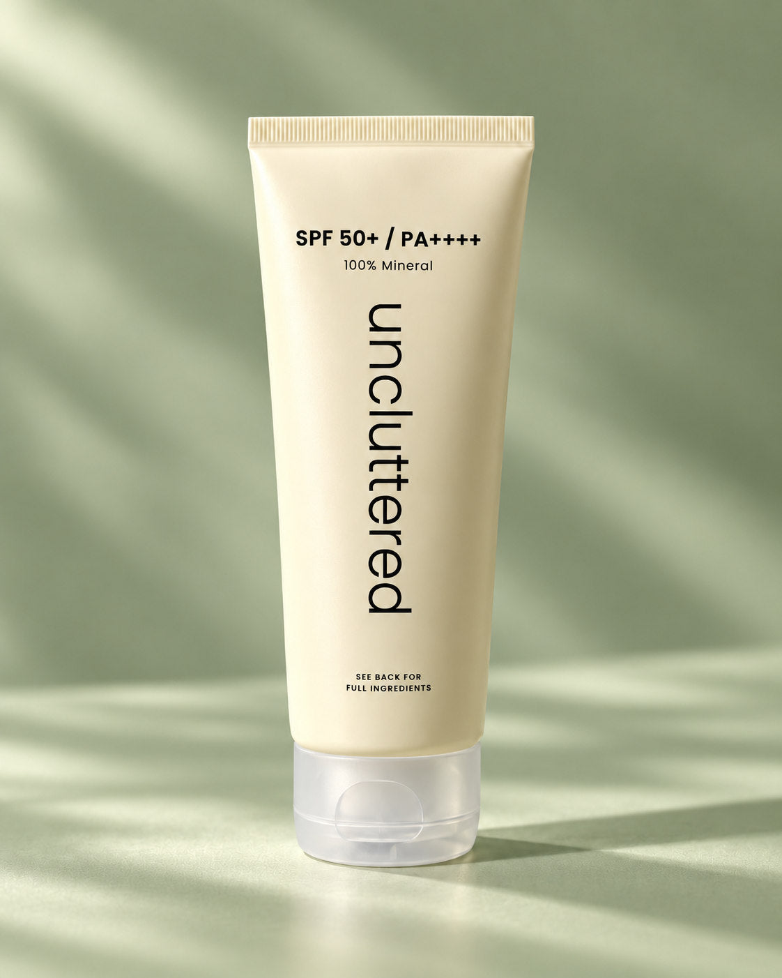 Uncluttered mineral sunscreen SPF 50+ PA++++ sealed tube on muted sage green background
